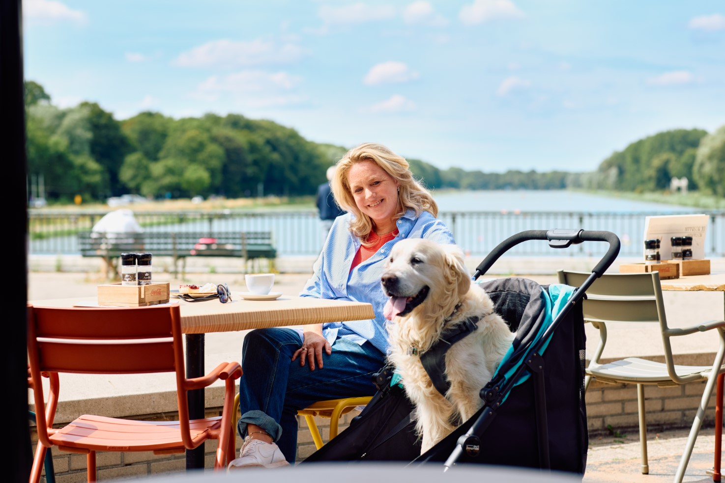 Woman with dog on terrace restaurant with dog stroller